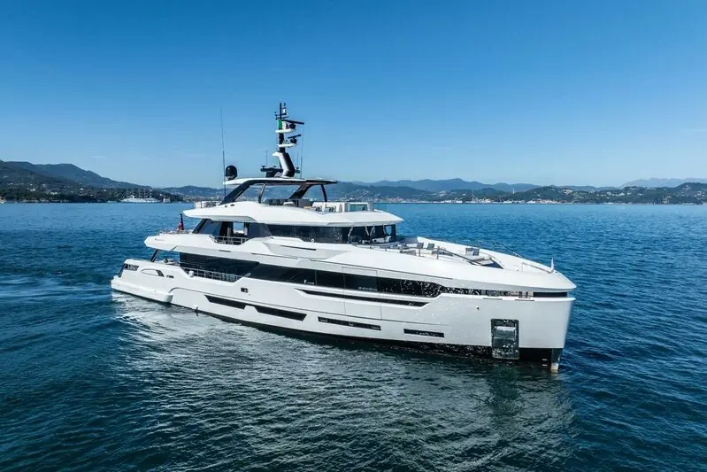 White motor yacht cruising on open water